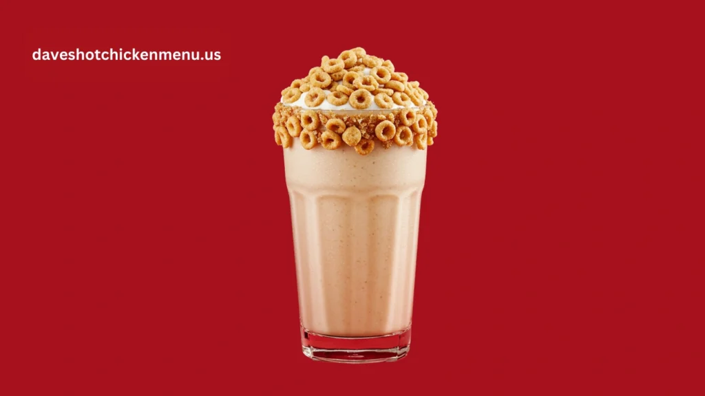 Creamy Cinnamon Toast Crunch milkshake topped with crunchy cereal and whipped cream in a glass.