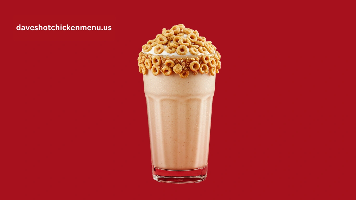 Creamy Cinnamon Toast Crunch milkshake topped with crunchy cereal and whipped cream in a glass.