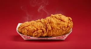 A single crispy chicken tender with signature seasoning
