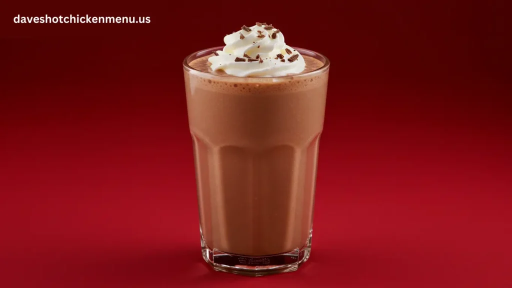 A creamy small chocolate shake in a glass with a straw.