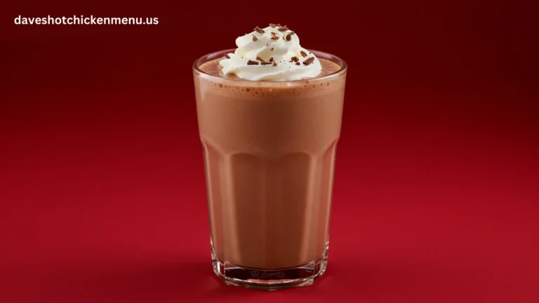 A creamy small chocolate shake in a glass with a straw.